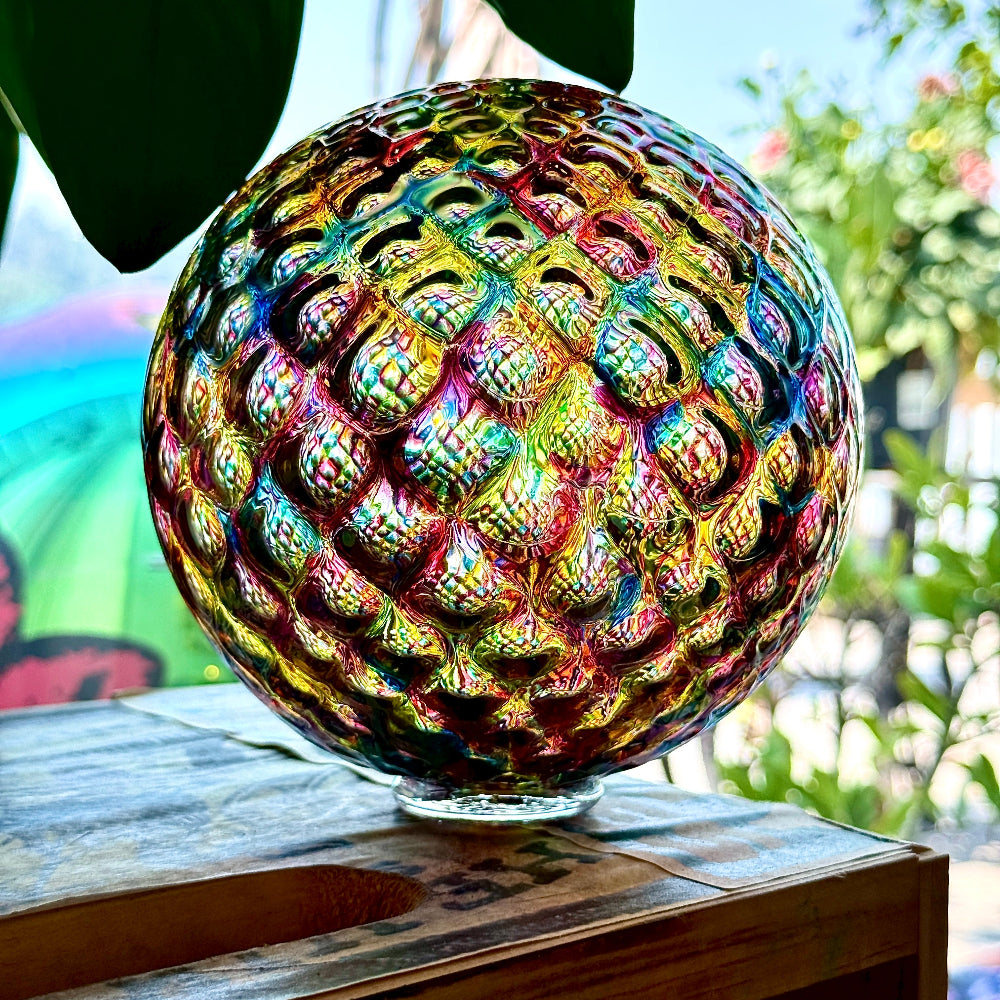 Colorful Rainbow Diamond Facet glass float with jewel-like facets reflecting light in a bright environment.