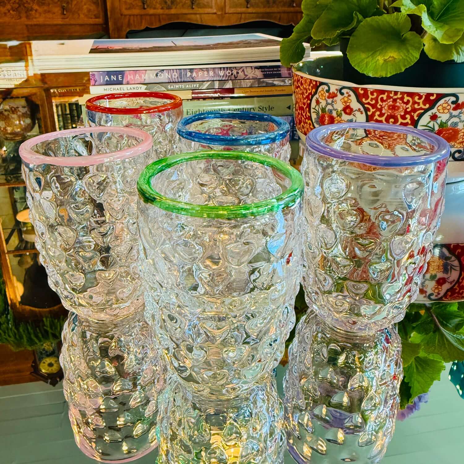 Colorful Love Cups featuring unique heart patterns and vibrant rims in pink, green, blue, and purple.